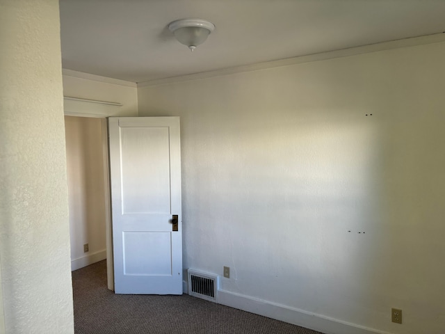 carpeted empty room with crown molding