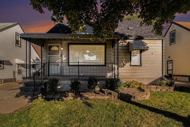 view of front of property featuring a lawn and covered porch