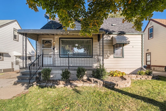 bungalow-style home featuring a porch and a front lawn