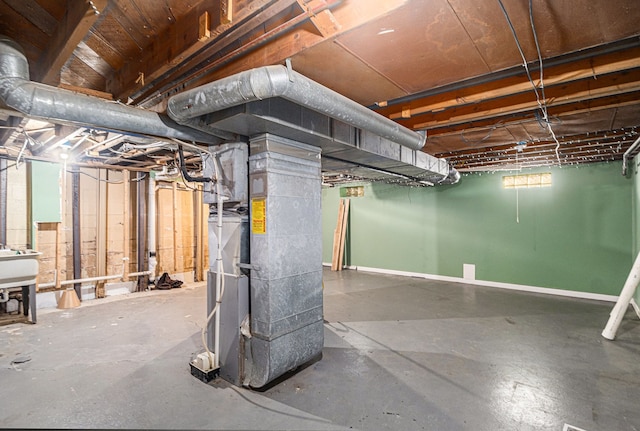 basement with sink and heating unit