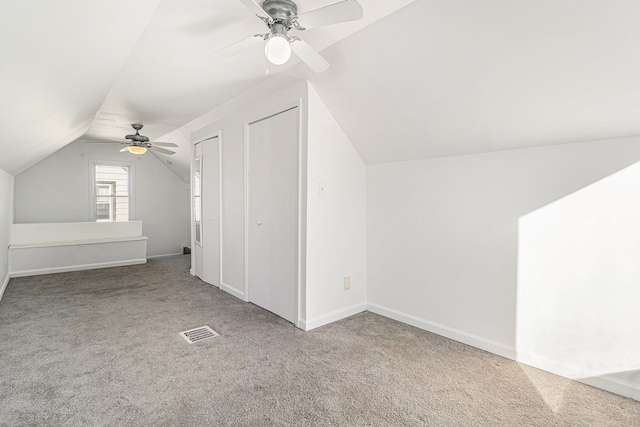 additional living space featuring ceiling fan, carpet floors, and vaulted ceiling