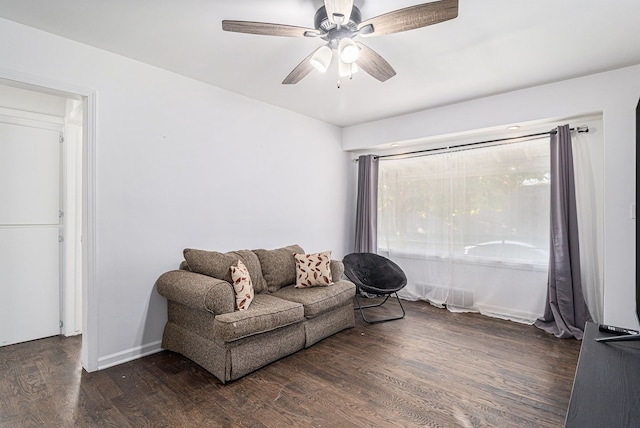 living room with dark hardwood / wood-style flooring and ceiling fan