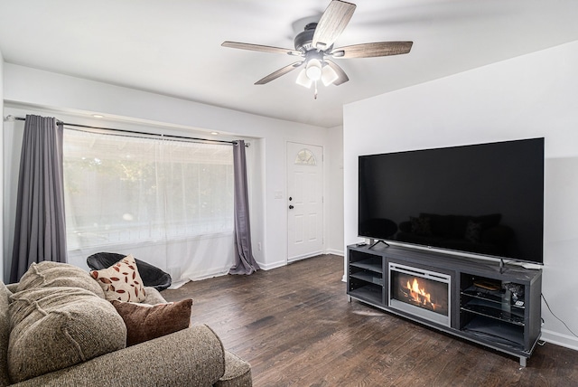 living room with dark hardwood / wood-style floors and ceiling fan