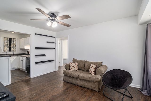 living room with ceiling fan and dark wood-type flooring