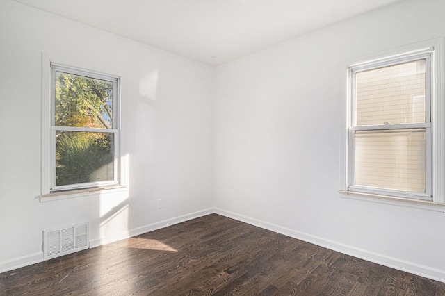 unfurnished room featuring dark hardwood / wood-style floors