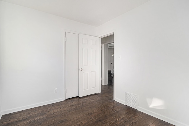 spare room featuring dark wood-type flooring