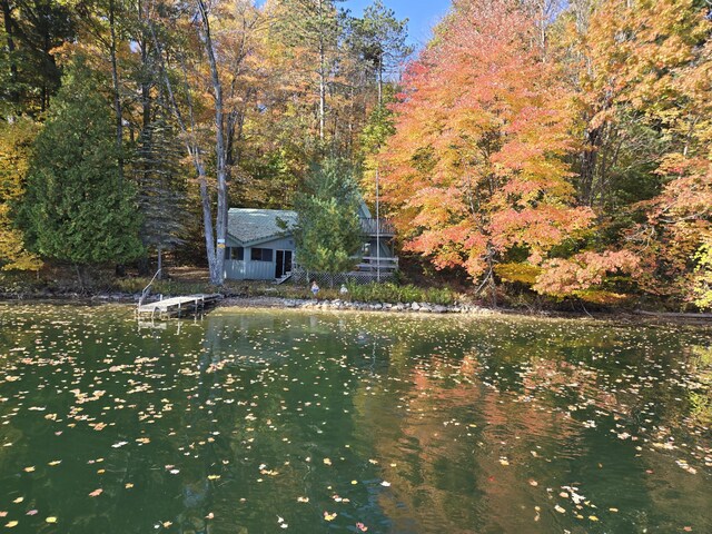 8918 W School Section Lake Dr, Mecosta, MI 49332 - view of front of house with a water view and a view of trees