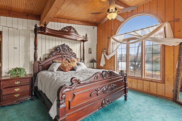 8918 W School Section Lake Dr, Mecosta, MI 49332 - carpeted bedroom featuring wood ceiling with exposed beams, wood walls, and ceiling fan
