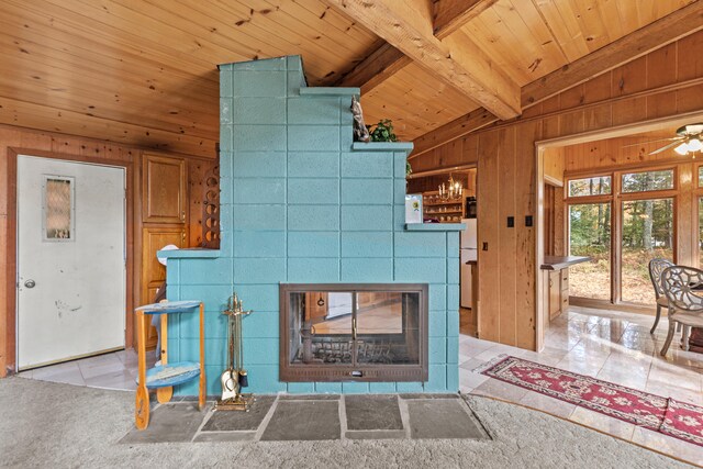 8918 W School Section Lake Dr, Mecosta, MI 49332 - detailed view of wood ceiling with exposed beams, wood walls, a tiled fireplace, and ceiling fan