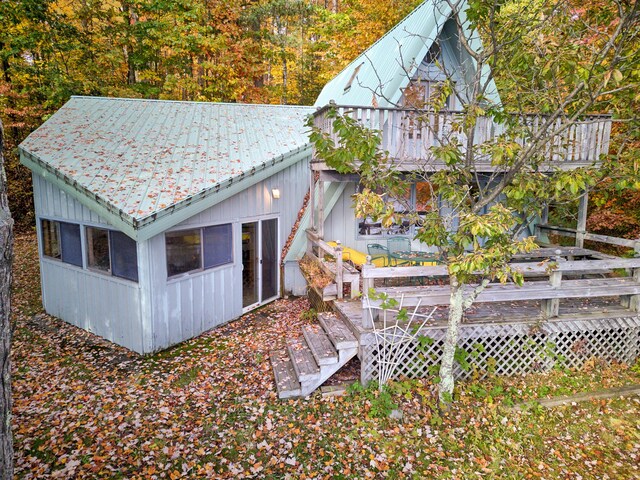 8918 W School Section Lake Dr, Mecosta, MI 49332 - back of property with a wooden deck and metal roof