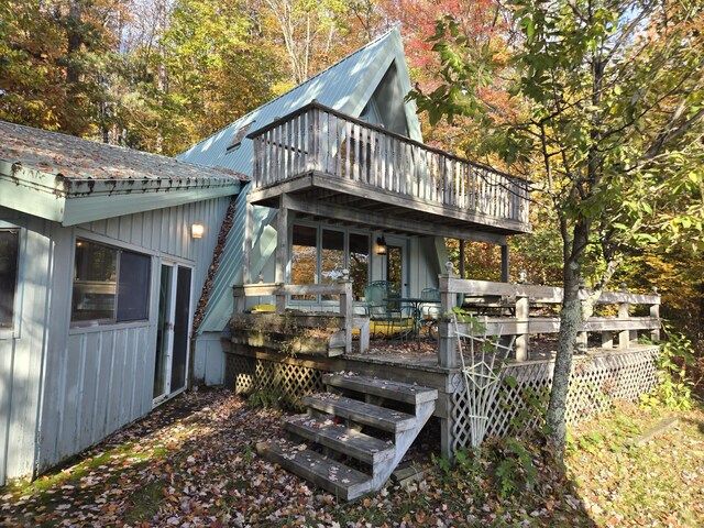 8918 W School Section Lake Dr, Mecosta, MI 49332 - back of house featuring metal roof and a wooden deck