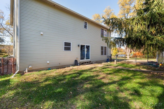 rear view of house featuring a yard