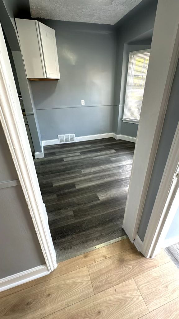 interior space with hardwood / wood-style flooring and a textured ceiling