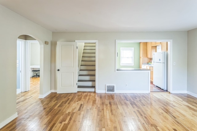 unfurnished living room featuring light hardwood / wood-style flooring