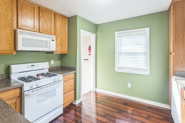 kitchen with dark hardwood / wood-style flooring and white appliances