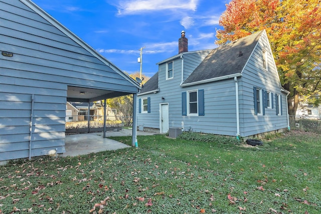 back of property featuring a yard, cooling unit, and a patio area