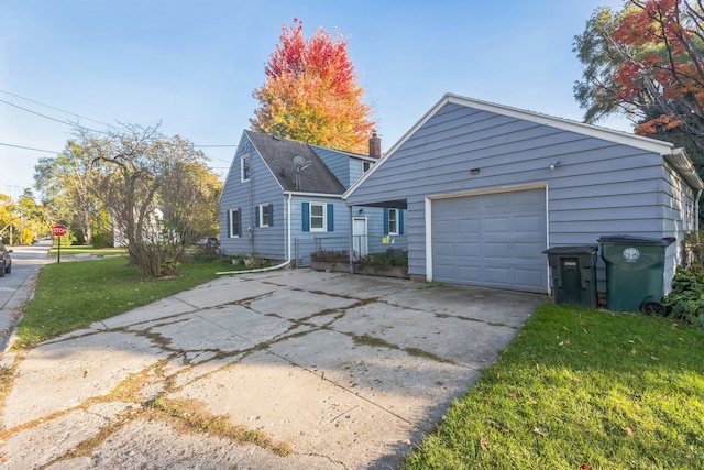 view of front facade with a garage, an outdoor structure, and a front lawn