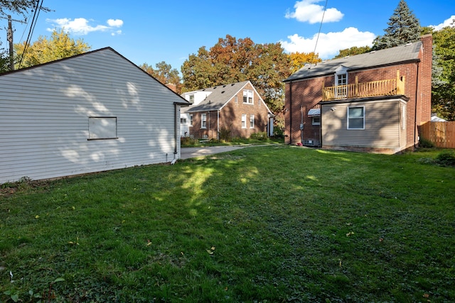 view of yard with a balcony