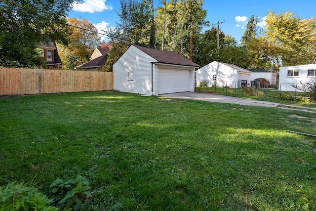 view of yard with a garage and an outdoor structure