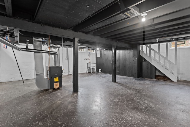 basement featuring sink and heating unit