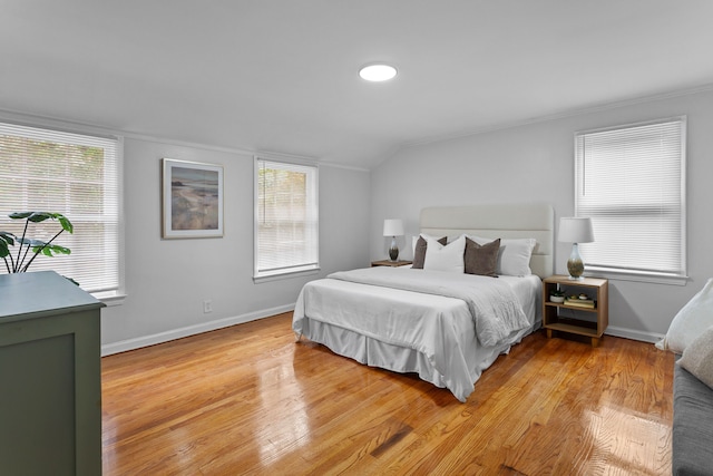 bedroom with hardwood / wood-style floors and vaulted ceiling