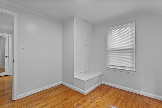 interior space with light hardwood / wood-style floors and crown molding