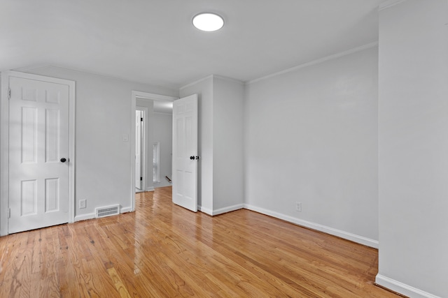 unfurnished bedroom with crown molding and light hardwood / wood-style flooring