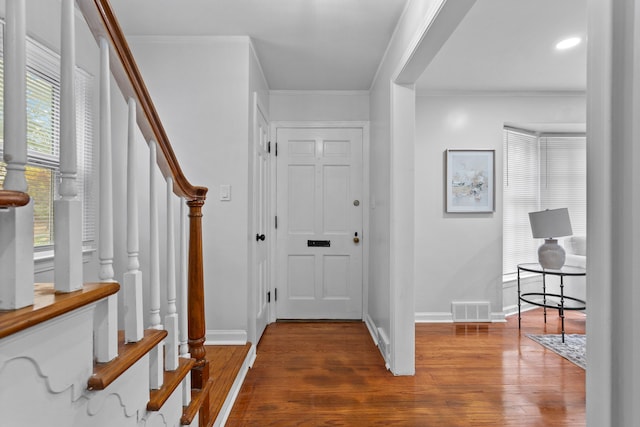 foyer featuring dark hardwood / wood-style floors and ornamental molding