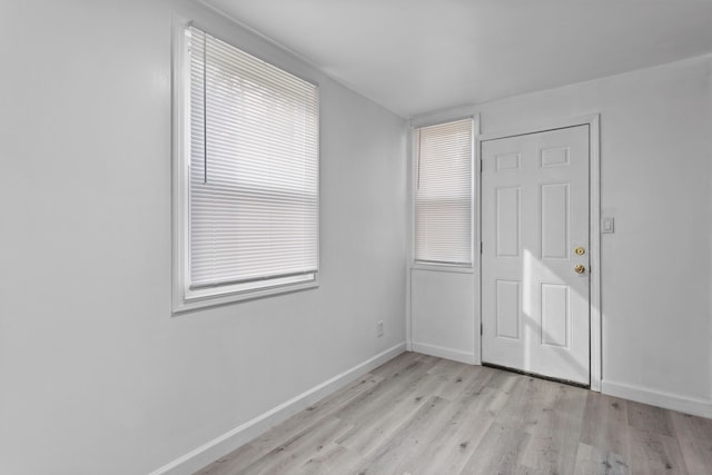 empty room with light hardwood / wood-style floors