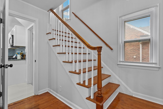 stairs featuring hardwood / wood-style floors