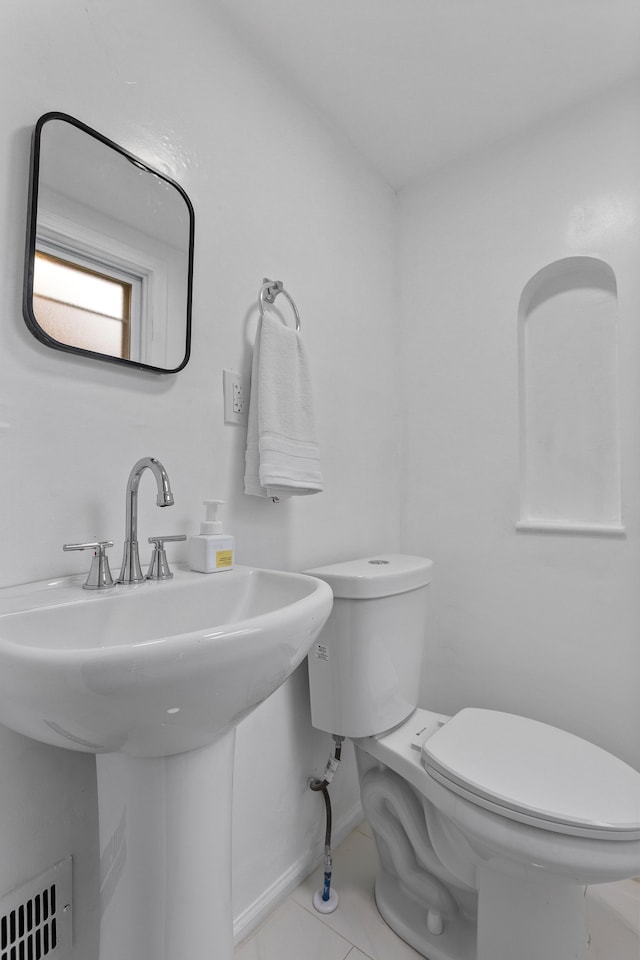 bathroom featuring tile patterned floors, sink, and toilet