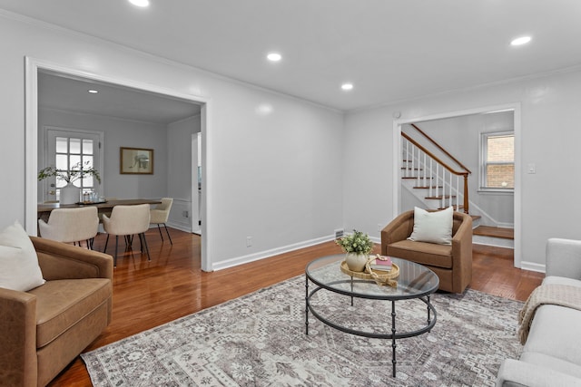 living room featuring wood-type flooring and ornamental molding