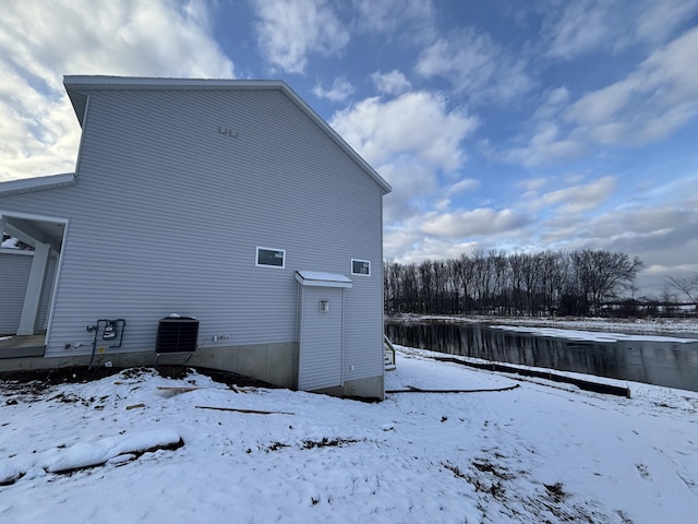 snow covered house with cooling unit