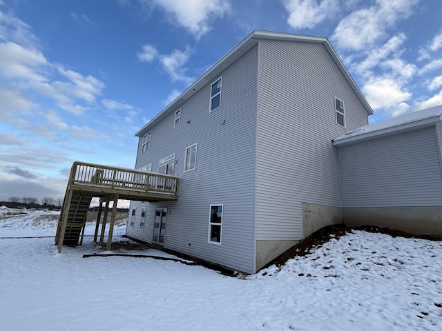 snow covered property featuring a wooden deck