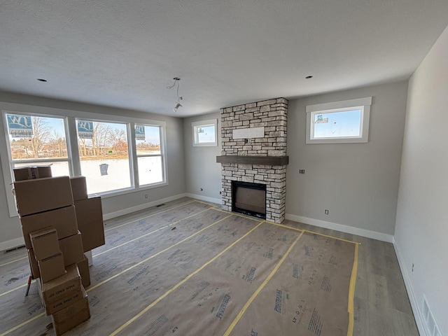 unfurnished living room with a fireplace and wood-type flooring