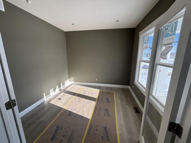 spare room featuring dark hardwood / wood-style flooring