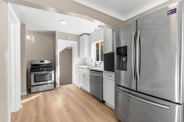 kitchen featuring white cabinetry, light hardwood / wood-style flooring, sink, and appliances with stainless steel finishes