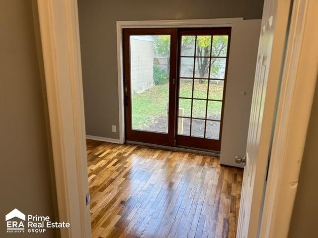 doorway with light wood-type flooring