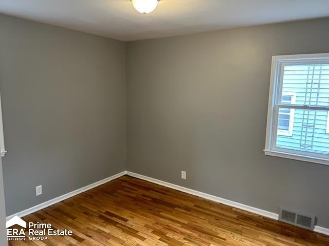 unfurnished room featuring hardwood / wood-style floors