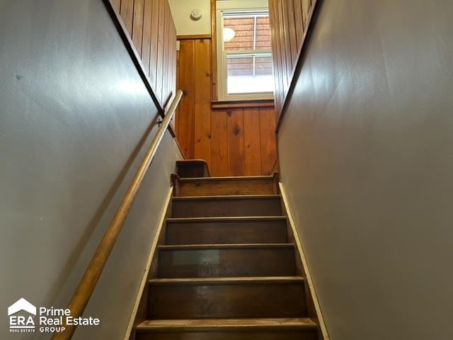 staircase with wooden walls