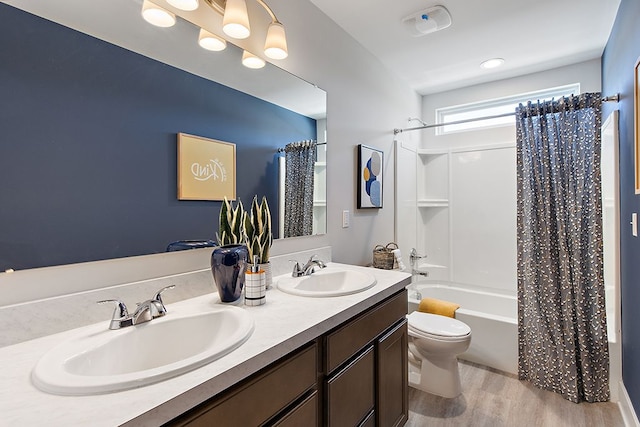 full bathroom with hardwood / wood-style floors, vanity, toilet, and shower / bathtub combination with curtain