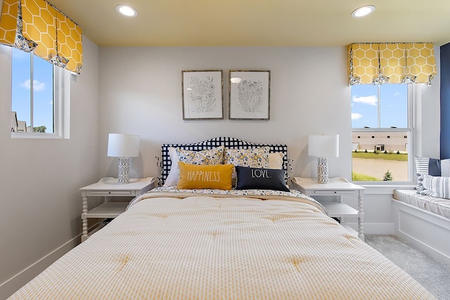 carpeted bedroom featuring multiple windows