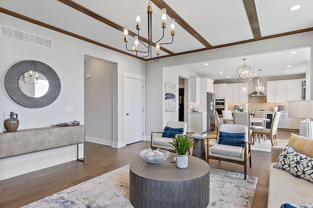 living room featuring crown molding, dark wood-type flooring, and a chandelier