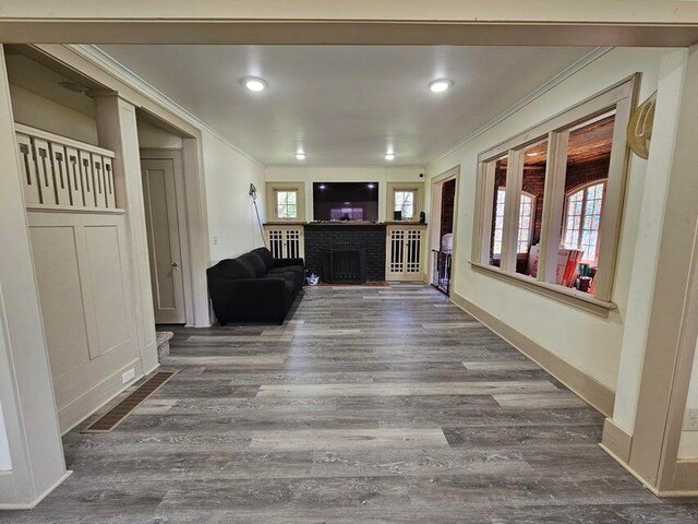 633 Marshall St, Allegan, MI 49010 - living area with crown molding, wood finished floors, a fireplace, baseboards, and recessed lighting