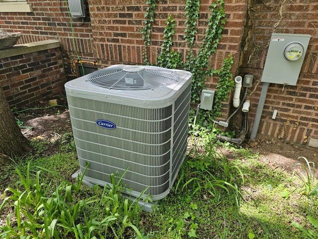 633 Marshall St, Allegan, MI 49010 - exterior view of central AC unit, electric meter, and brick siding