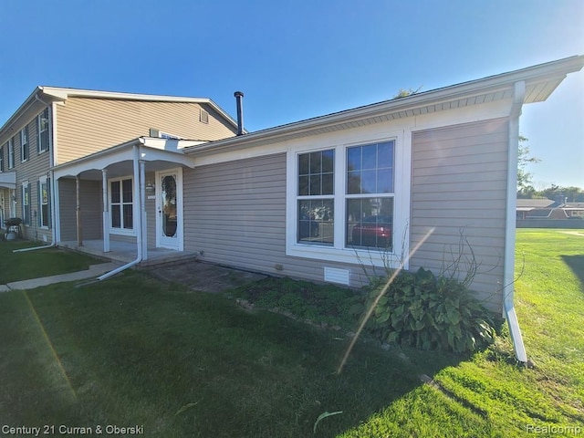 rear view of house with a lawn