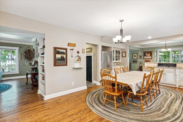 dining area with hardwood / wood-style floors and an inviting chandelier