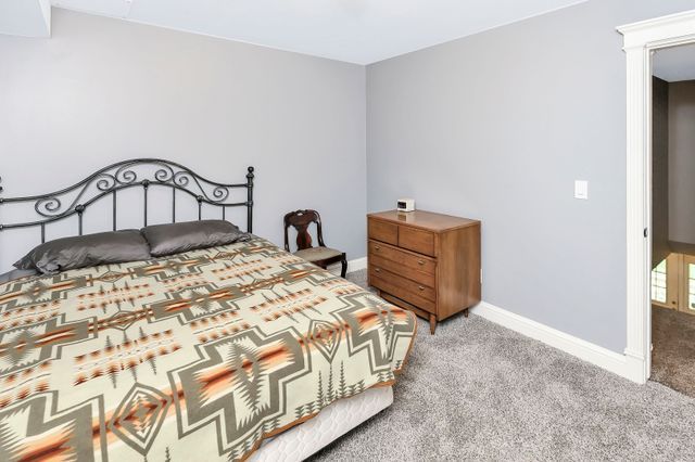 bedroom featuring light colored carpet