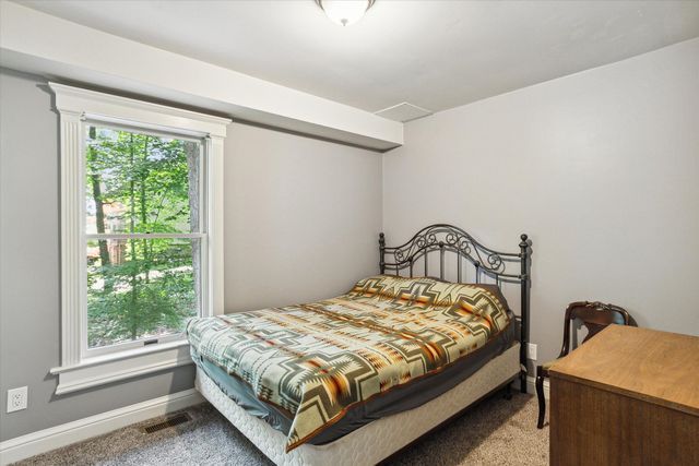 carpeted bedroom featuring multiple windows