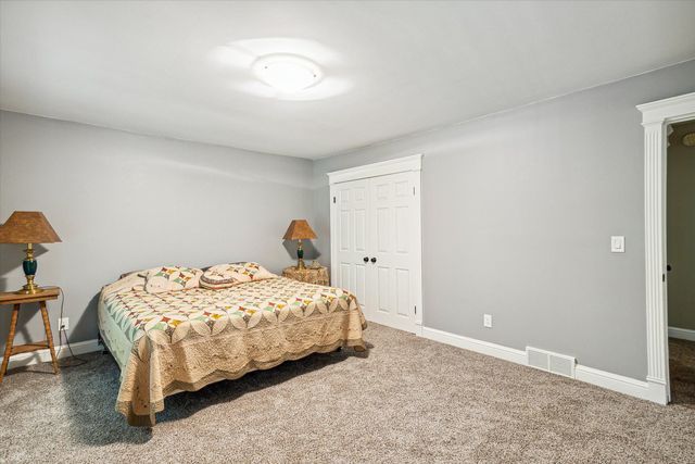 carpeted bedroom with a closet